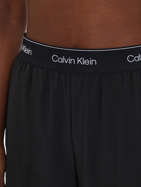 CK PERFORMANCE Pantal&oacute;n palazzo con el&aacute;stico con logo belleza negra - trajes deportivos para mujeres