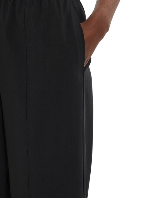 CK PERFORMANCE Pantal&oacute;n palazzo con el&aacute;stico con logo belleza negra - trajes deportivos para mujeres