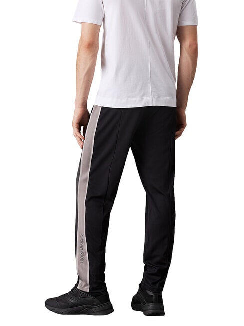 CK PERFORMANCE Pantalones de ch&aacute;ndal con logotipo lateral belleza negra - Trajes deportivos para hombres